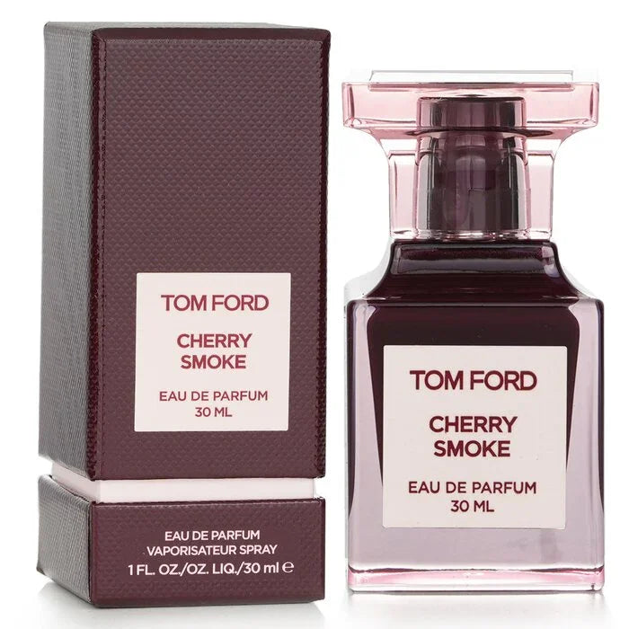 A 30ml Tom Ford Cherry Smoke Eau De Parfum bottle with translucent burgundy glass and dark cherry-colored liquid, standing next to its matching textured burgundy-red gift box with a white-and-burgundy logo label.
