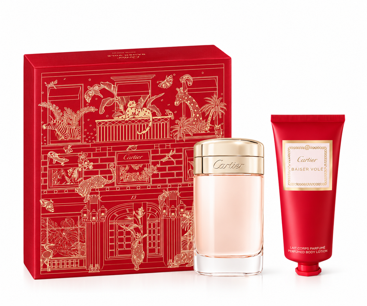 Cartier Baiser Volé gift set featuring the elegant Baiser Volé perfume bottle and matching perfumed body lotion, presented with a luxurious red and gold illustrated Cartier gift box.
