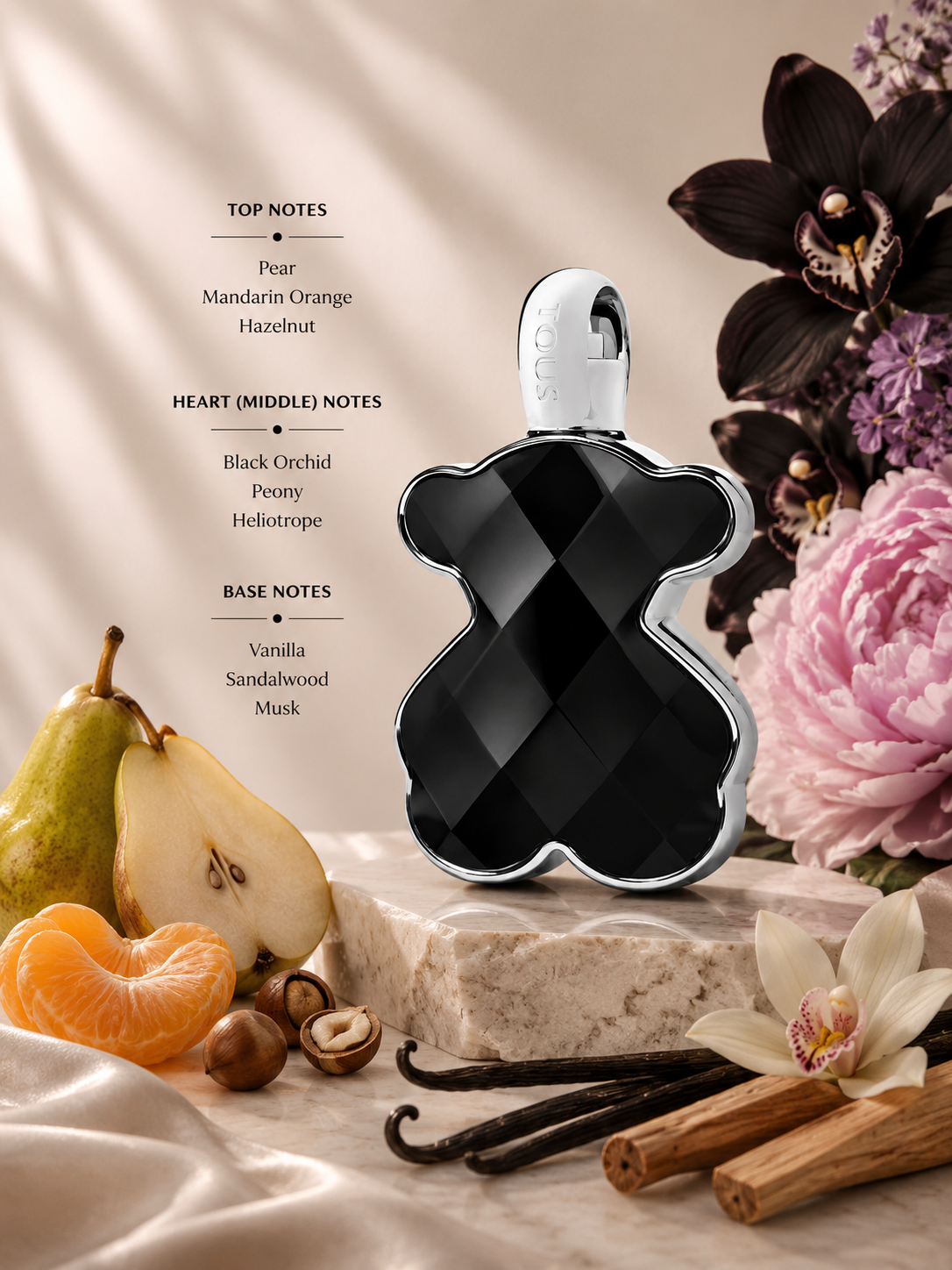 Tous LoveMe The Onyx Parfum displayed with pear, mandarin orange, black orchid, and vanilla accents. Notes shown:
Top: Pear, Mandarin Orange, Hazelnut
Heart: Black Orchid, Peony, Heliotrope
Base: Vanilla, Sandalwood, Musk
A rich floral-gourmand fragrance blending juicy fruits and creamy hazelnut with dark floral notes, resting on a warm base of vanilla, sandalwood, and musk. Presented in the signature faceted black bear-shaped bottle with polished silver detailing.