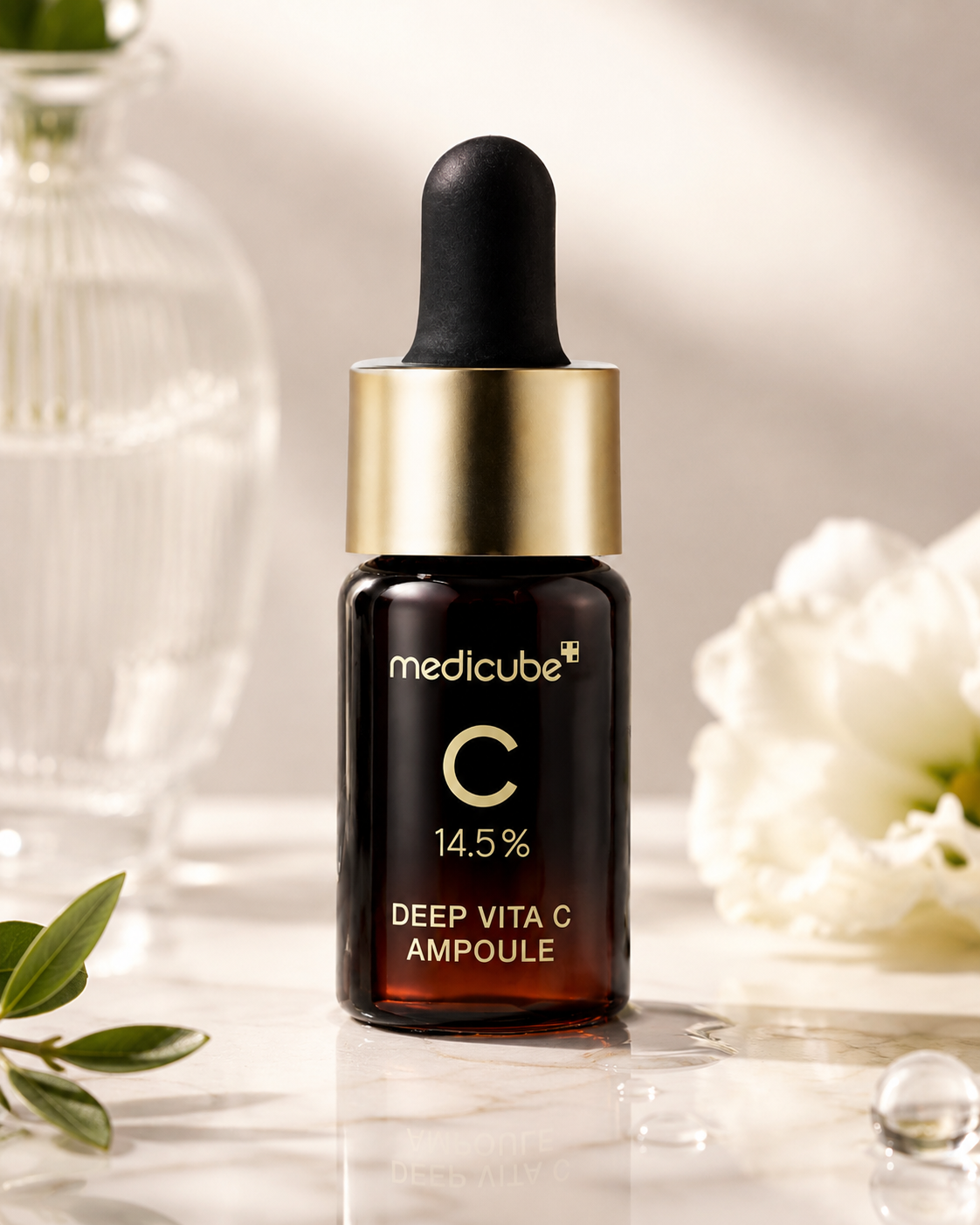 Medicube Deep Vita C Ampoule 2.0 30g on a light background with flowers and leaves.