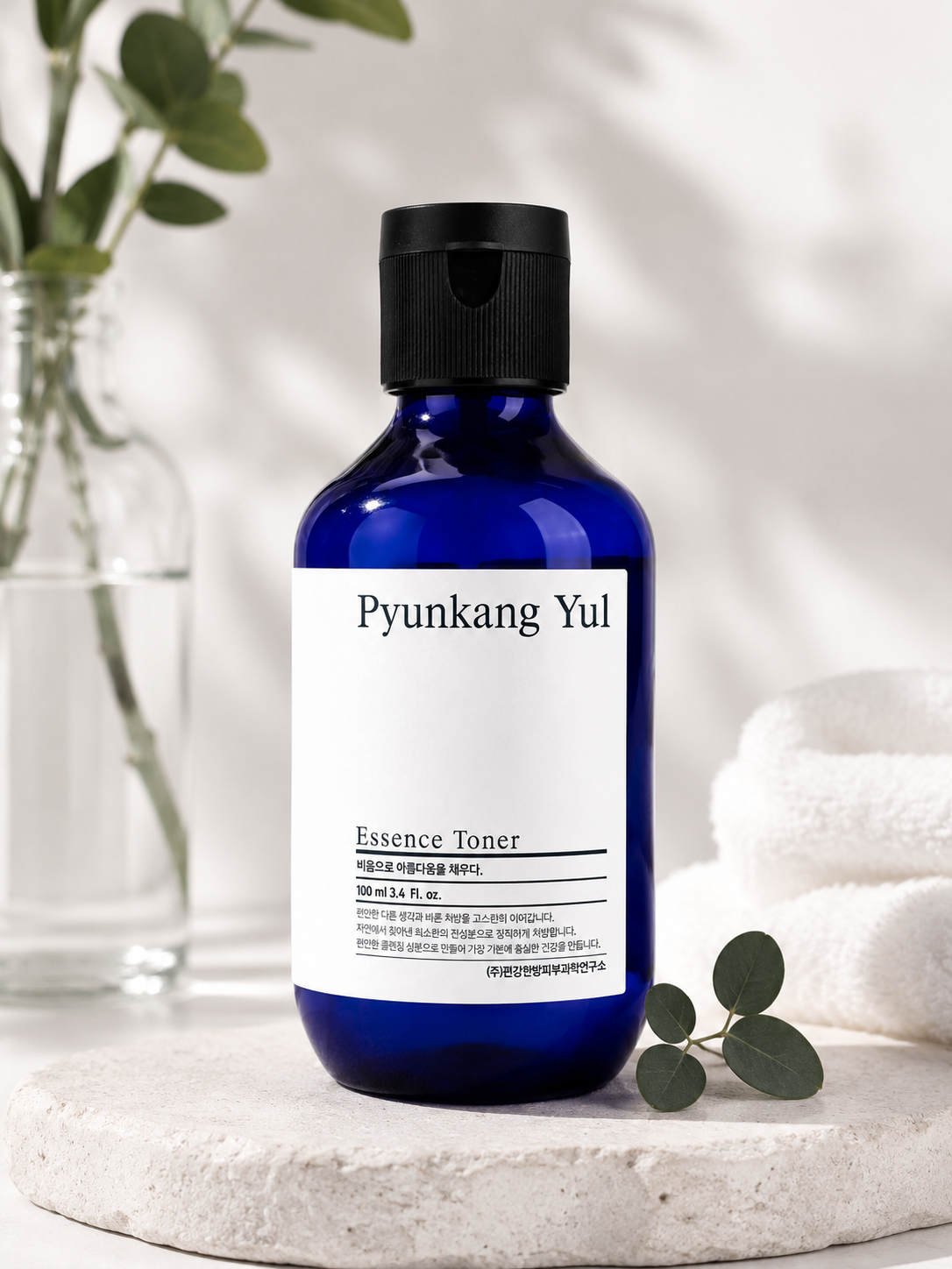 Pyunkang Yul Essence Toner 100ml on a white surface, clean and aesthetic background.