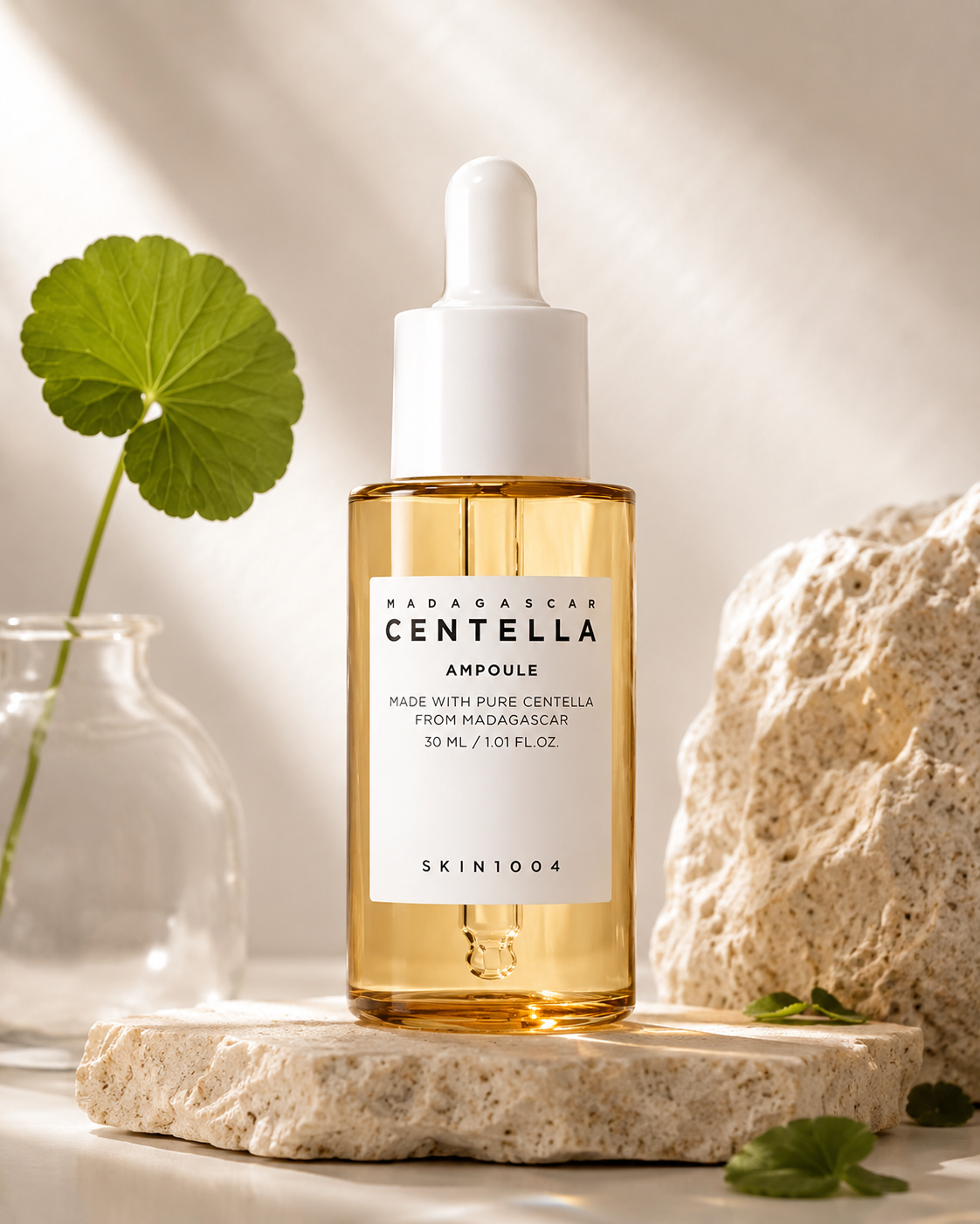 SKIN1004 Madagascar Centella Ampoule 30ml on a stone surface with a leafy plant in the background.
