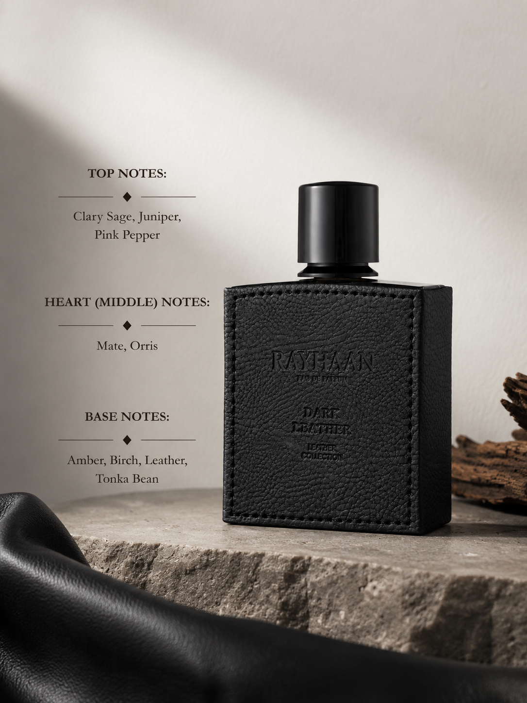 Rayhaan Dark Leather fragrance bottle displayed with leather accents, wood, and stone elements alongside fragrance notes featuring clary sage, juniper, pink pepper, mate, orris, amber, birch, leather, and tonka bean.