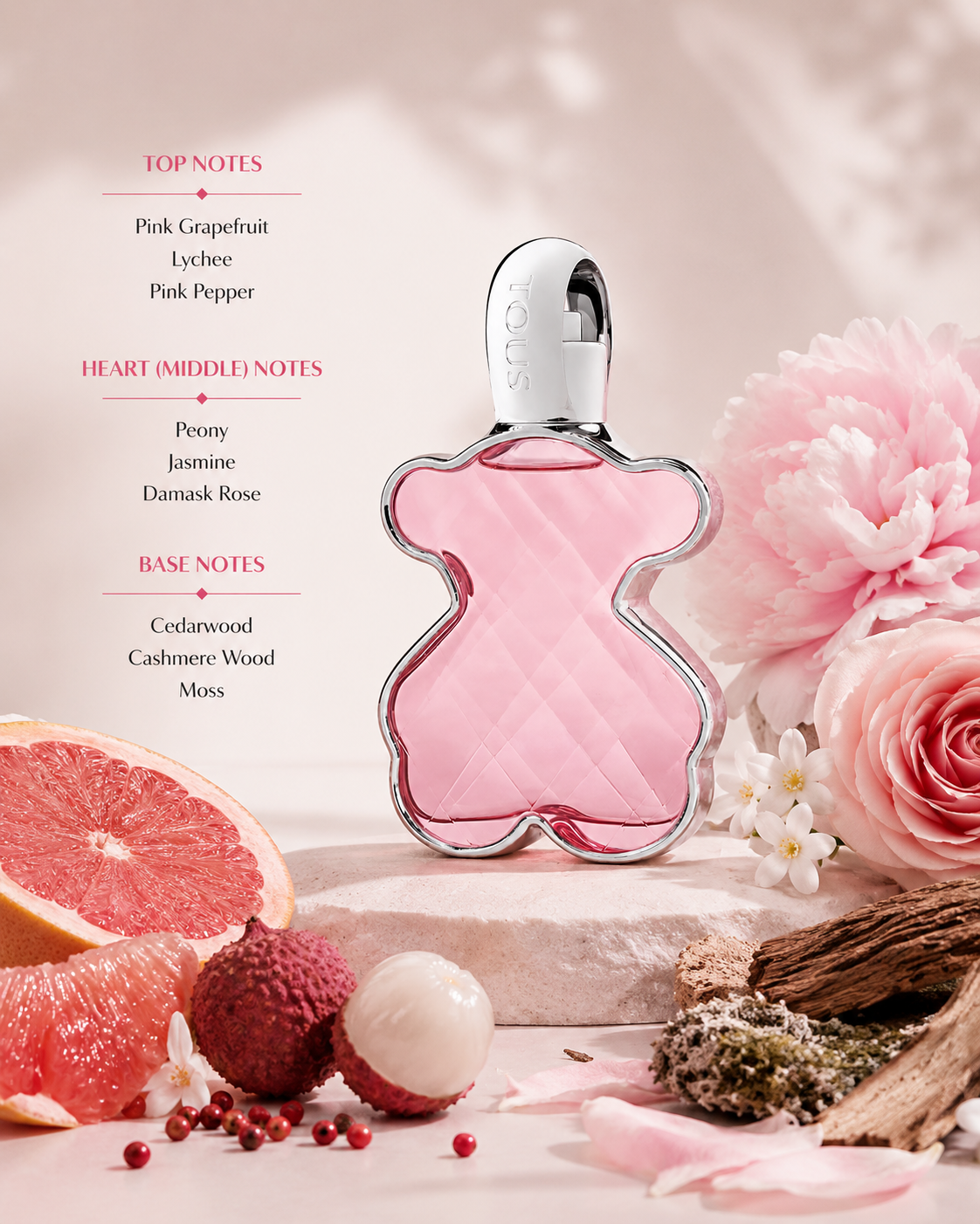 Tous LoveMe Eau de Parfum displayed with grapefruit, lychee, peony, and cedarwood accents. Notes shown:
Top: Pink Grapefruit, Lychee, Pink Pepper
Heart: Peony, Jasmine, Damask Rose
Base: Cedarwood, Cashmere Wood, Moss
A sparkling floral-fruity fragrance that combines juicy citrus and lychee with elegant peony and rose, finishing on a soft woody base. Presented in the signature faceted pink bear-shaped bottle with polished silver detailing.