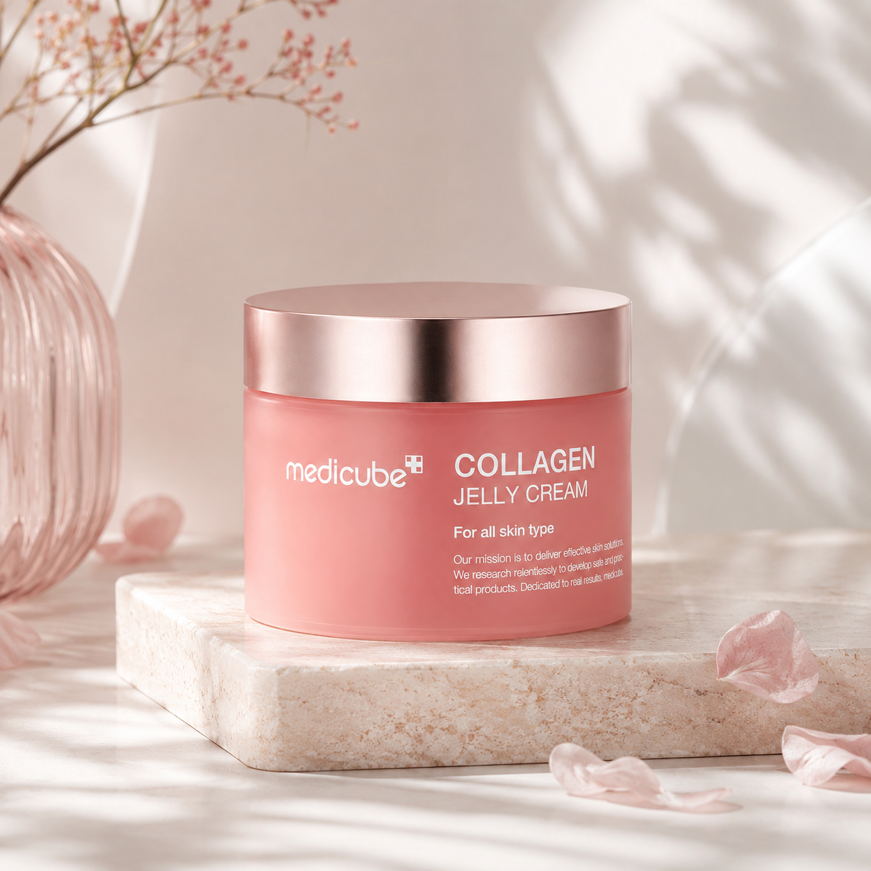 Pink jar of Medicube Collagen Jelly Cream on a light background
